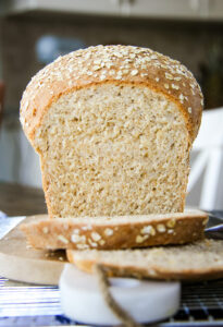 a front view of a loaf of oatmeal bread cut into slices