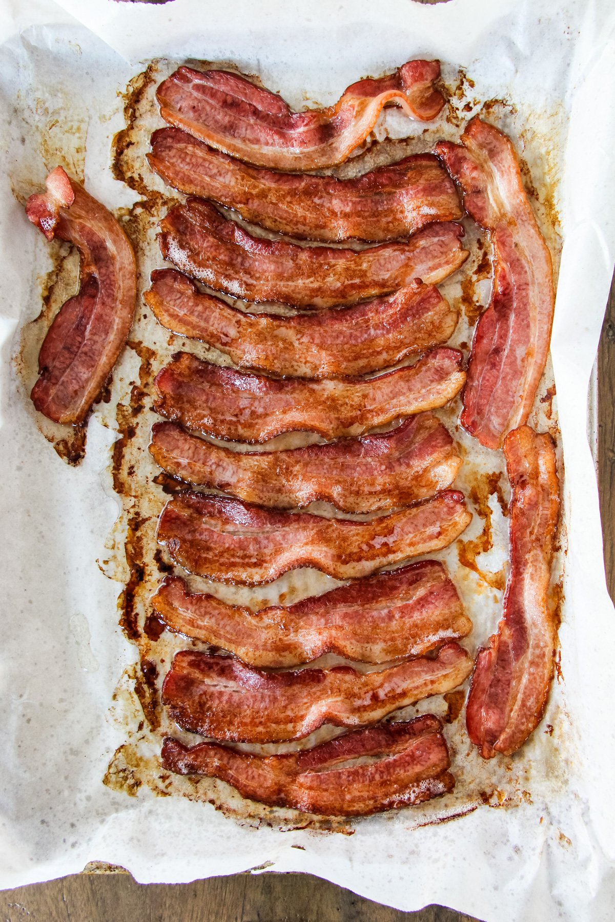 a top down image of a baking tray filled with cooked bacon
