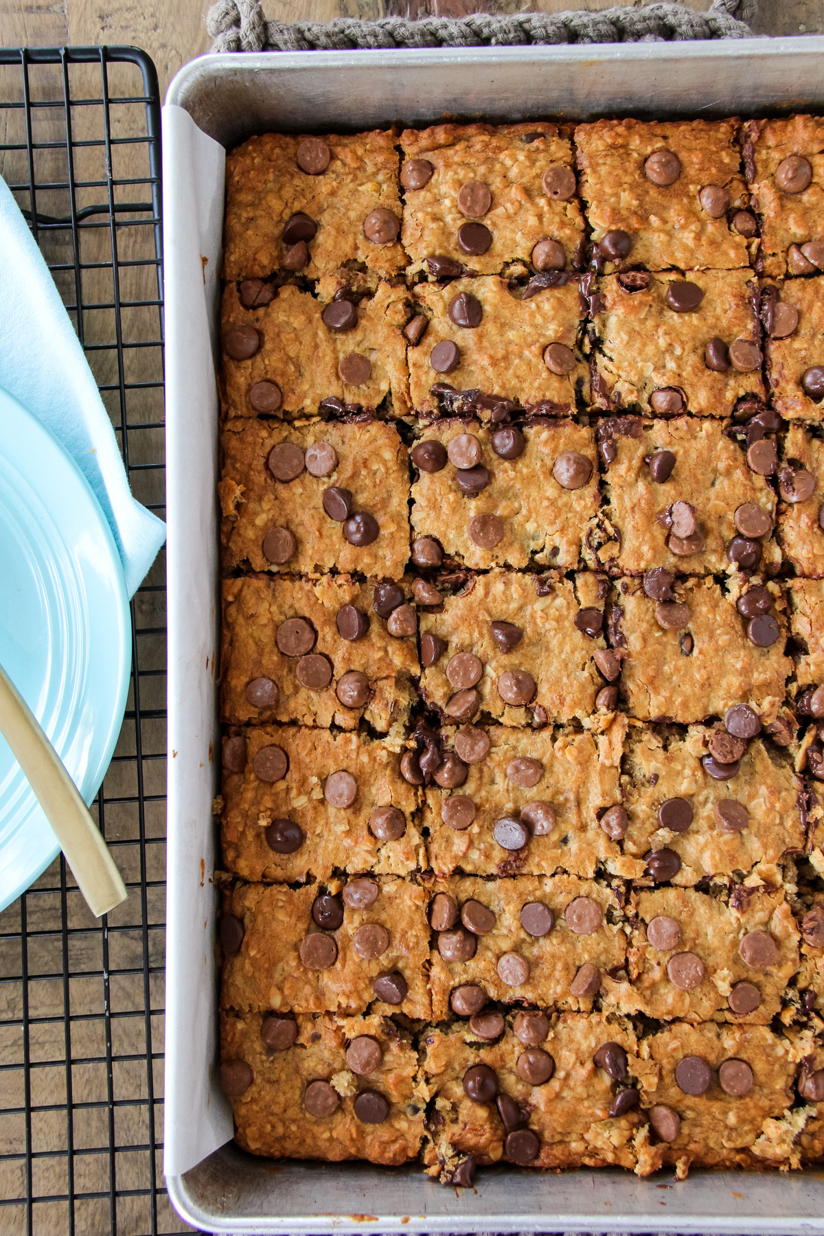 a top down view of baking pan of Peanut Butter Chocolate Chip Banana Oatmeal Bars cut into squares