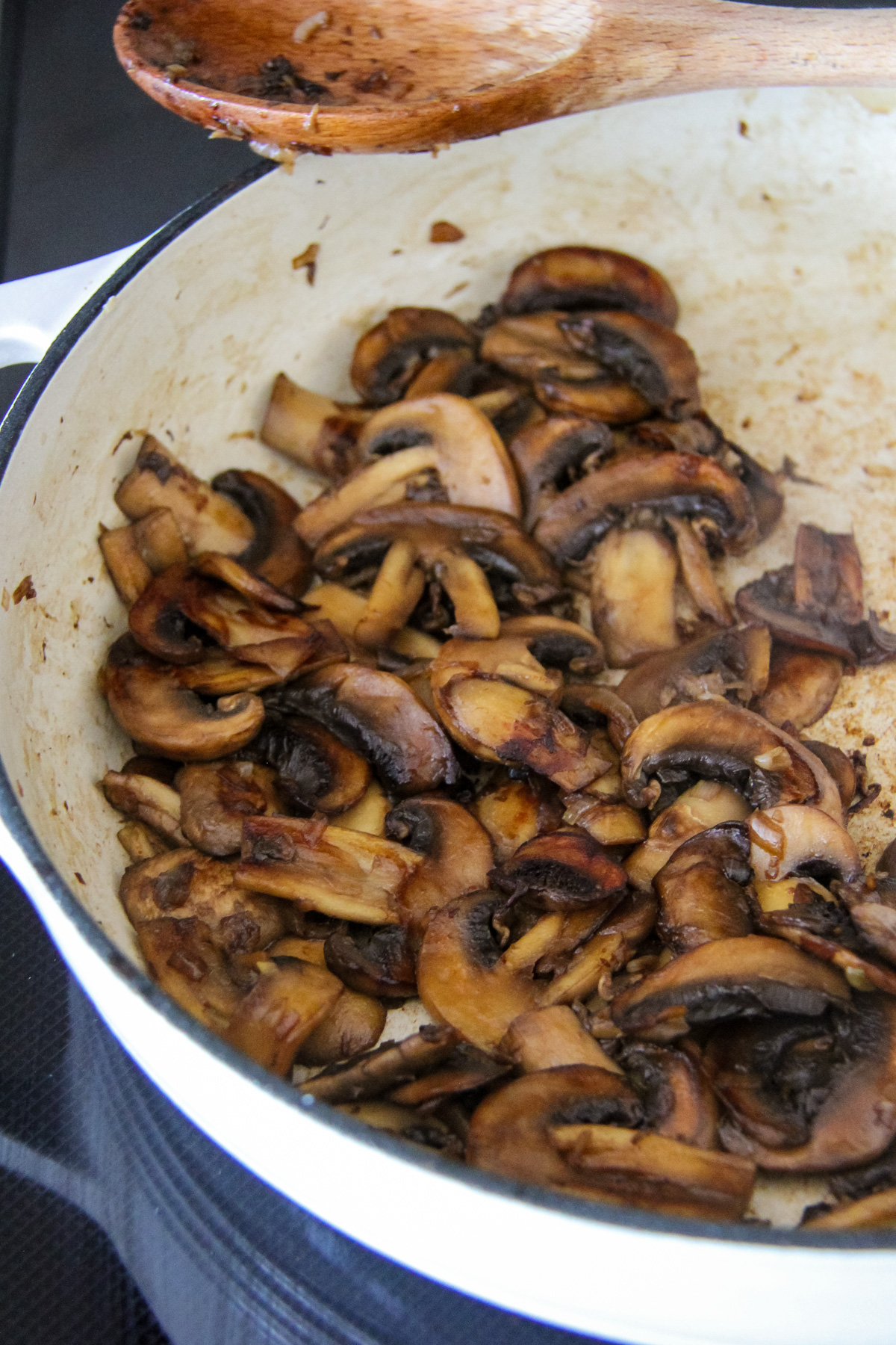 an enamel dish filled with sliced cooked mushrooms
