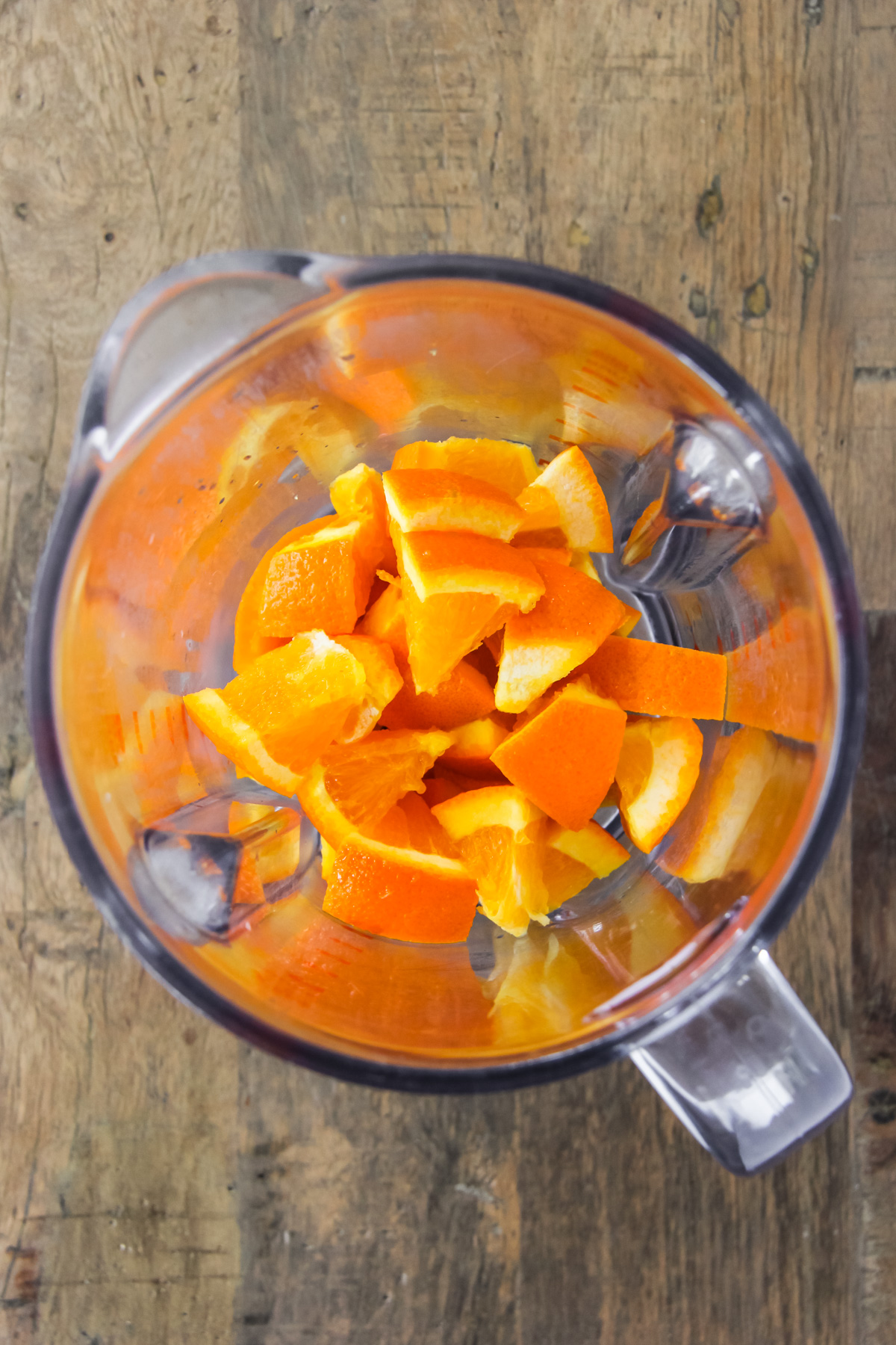 a top down view of a blender filled with orange pieces