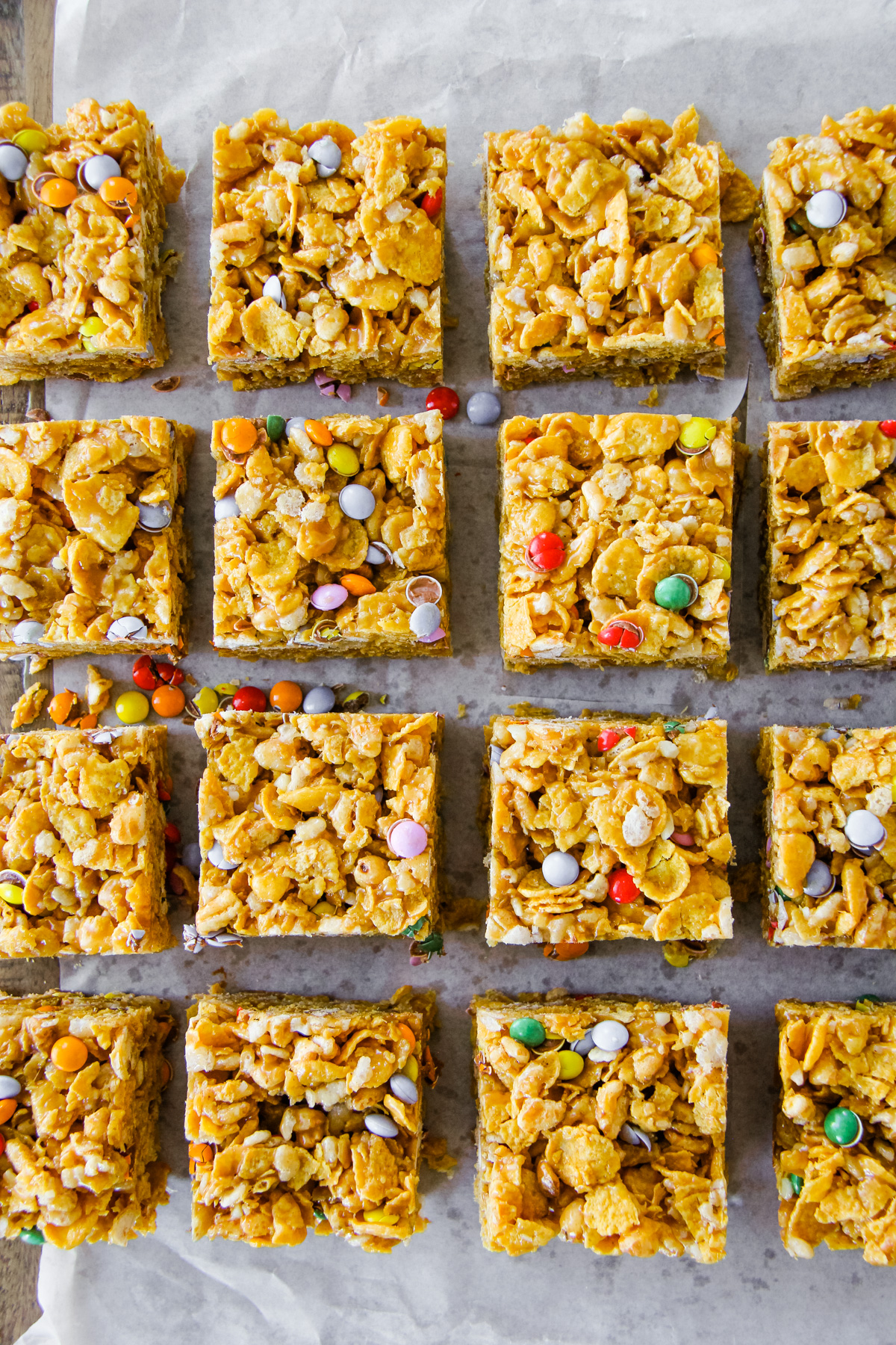 a top down image of Peanut Butter Puffed Wheat Squares with coloured candy coated chocolate