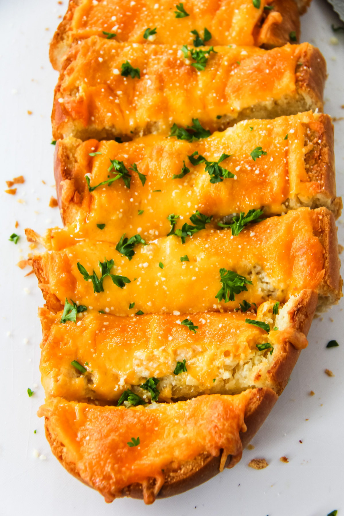 a loaf of cheesy garlic bread cut into slices