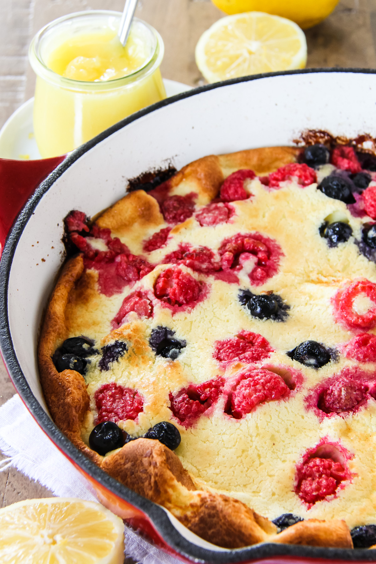a dutch berry pancake with raspberries and blueberries
