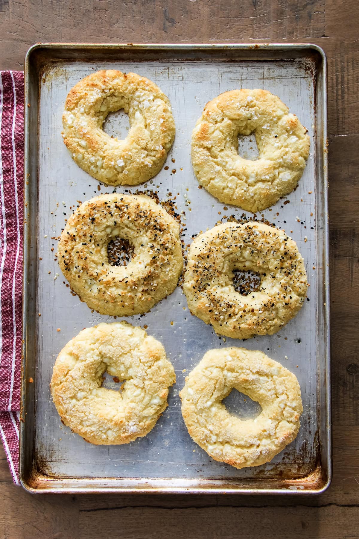 a top down image of baked Cottage Cheese Bagels on a baking sheet