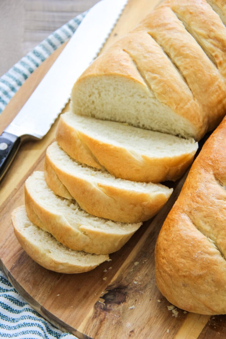 loaves of French bread on a wooden cutting board