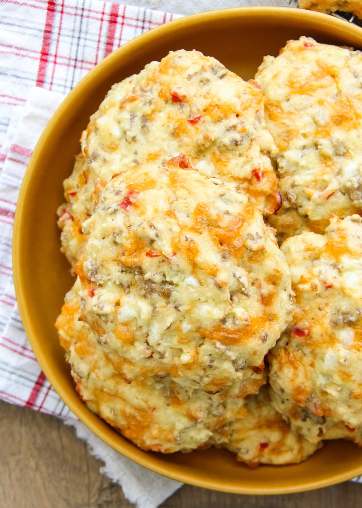 a top down image of a plate full of sausage breakfast biscuits