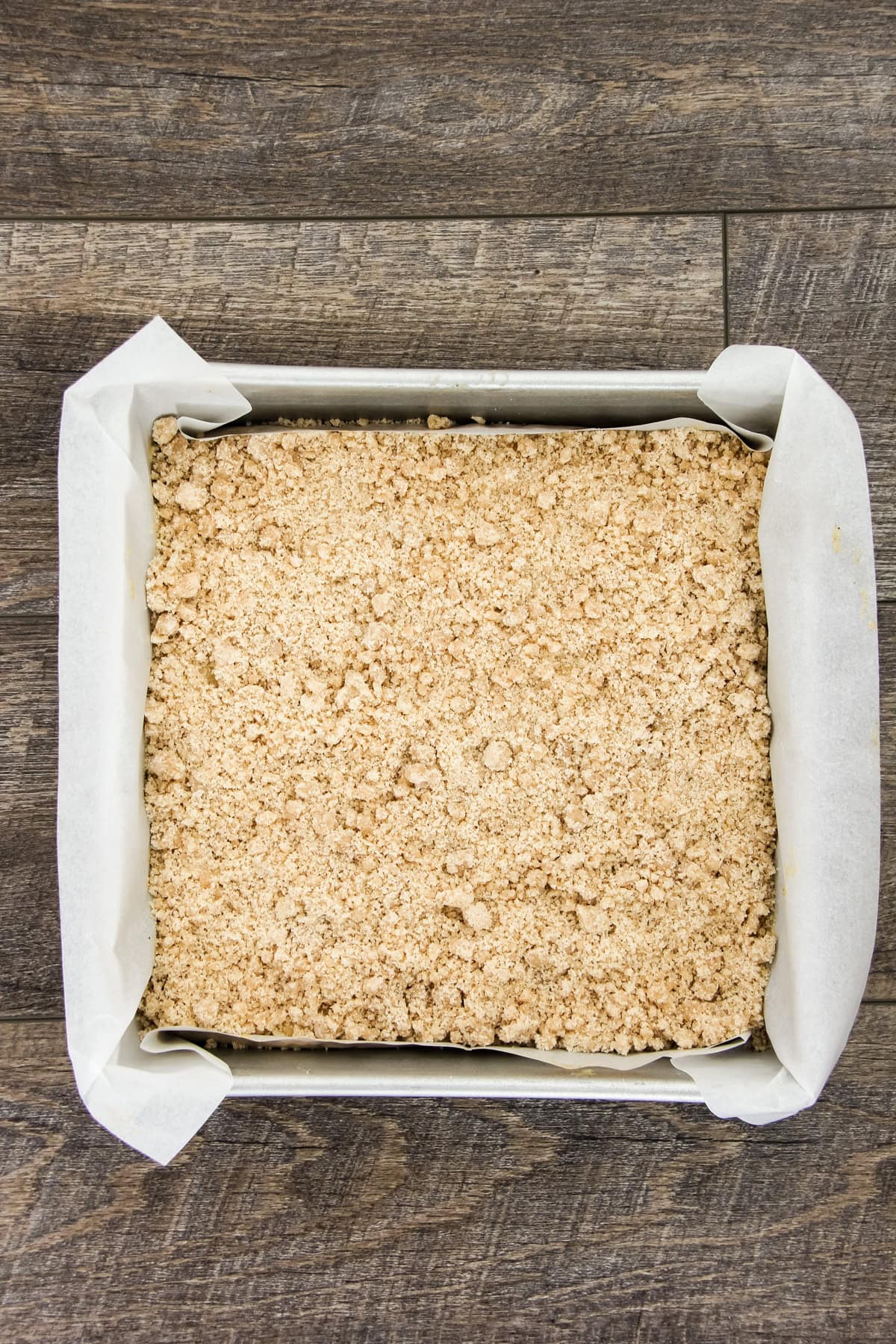 a top down image of an unbaked pumpkin spice coffee cake