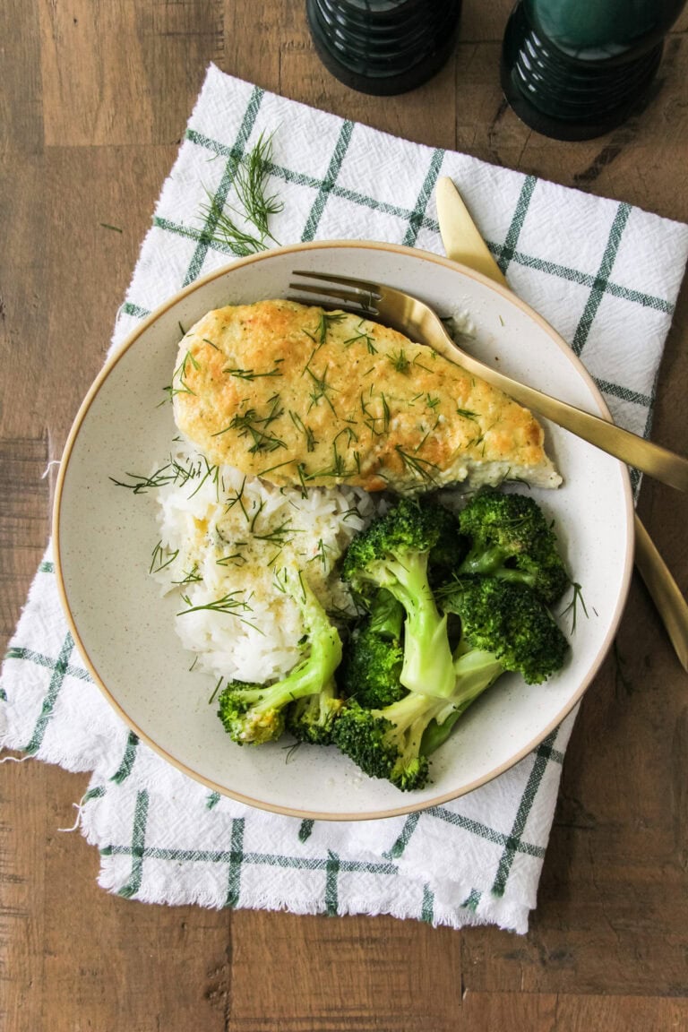 a plate with creamy parmesan chicken, broccoli and rice