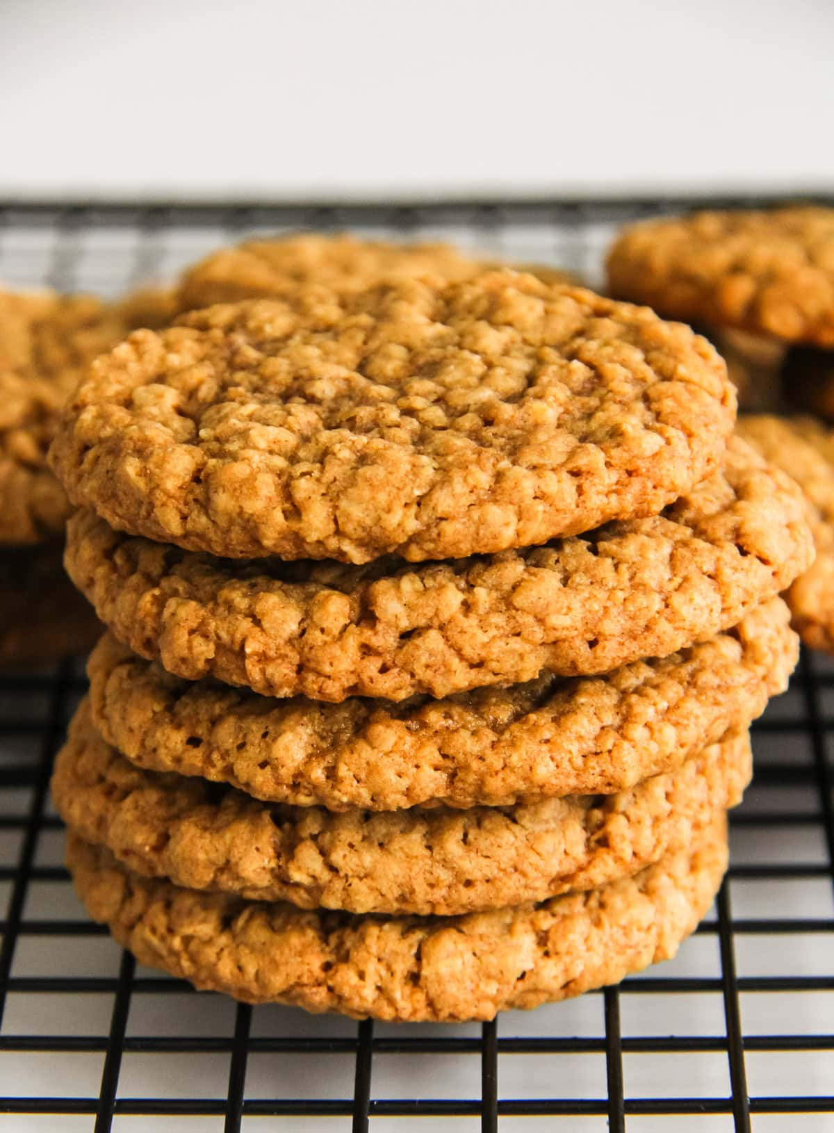 a stack of Chewy Ginger Oatmeal Cookies on a wire baking rack