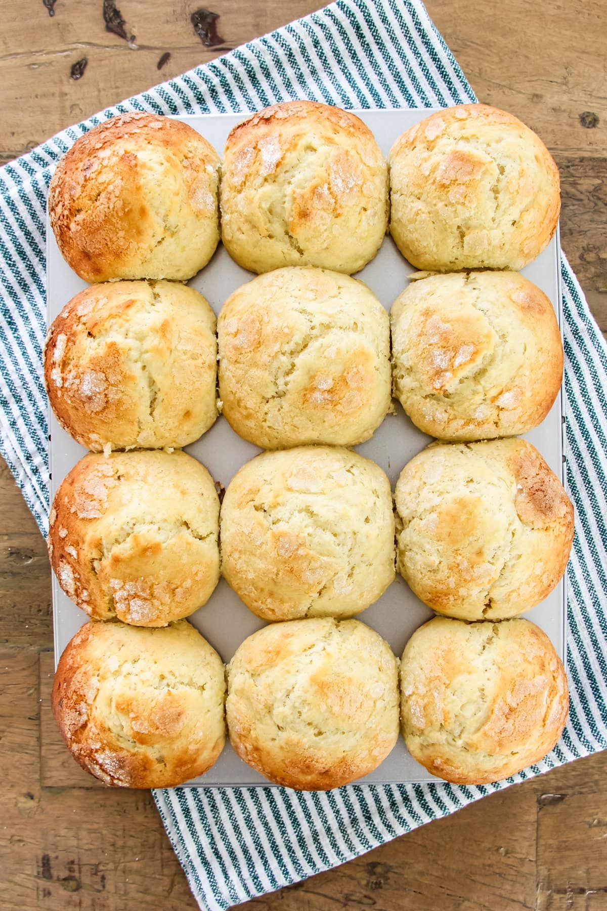 a top down image of a muffin tin of banana buttermilk muffins